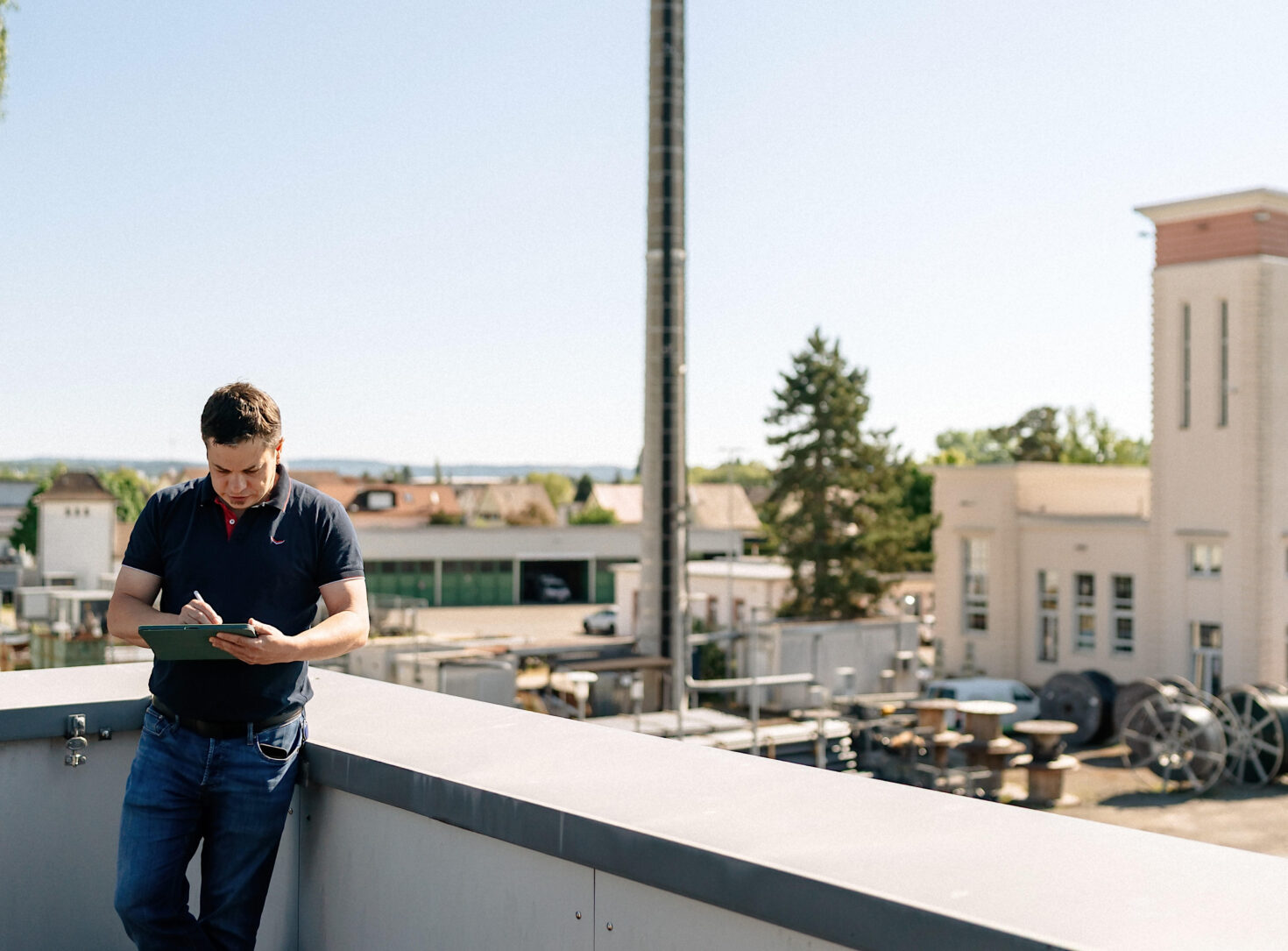 Mitarbeiter mit Tablet auf Dachterrasse